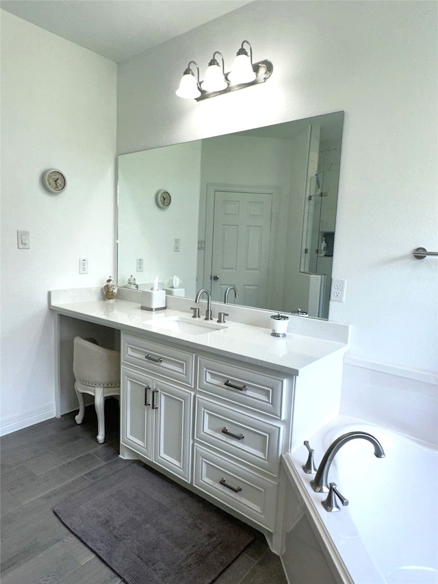 bathroom featuring vanity, a bath, and hardwood / wood-style flooring