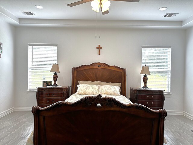 bedroom with recessed lighting, visible vents, baseboards, and wood finished floors