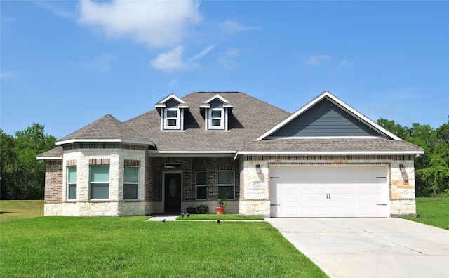 view of front of home featuring driveway, a front lawn, roof with shingles, and an attached garage