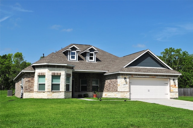 view of front of house featuring a garage, brick siding, driveway, roof with shingles, and a front yard