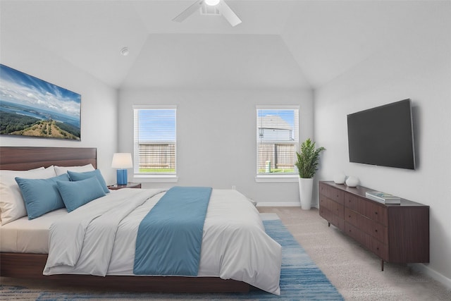 bedroom with multiple windows, light colored carpet, and lofted ceiling