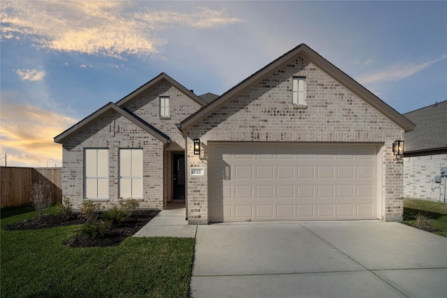 view of front facade featuring an attached garage, fence, brick siding, and driveway