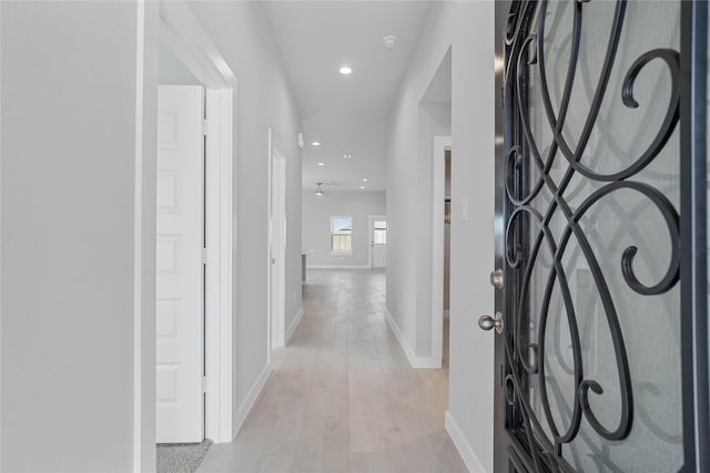 foyer with recessed lighting, baseboards, and light wood finished floors