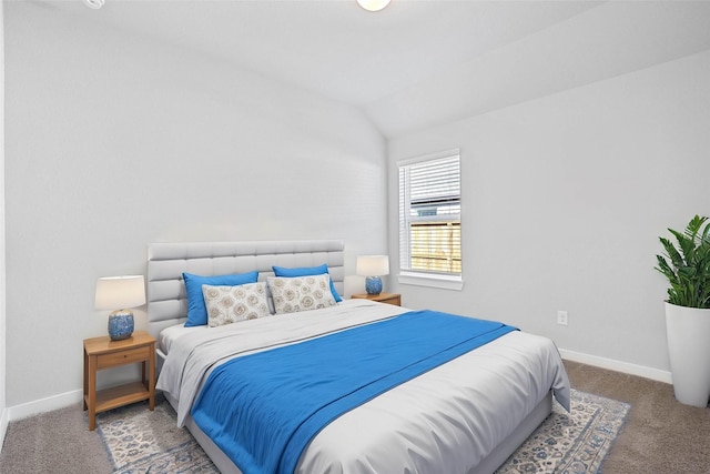 carpeted bedroom with baseboards and lofted ceiling