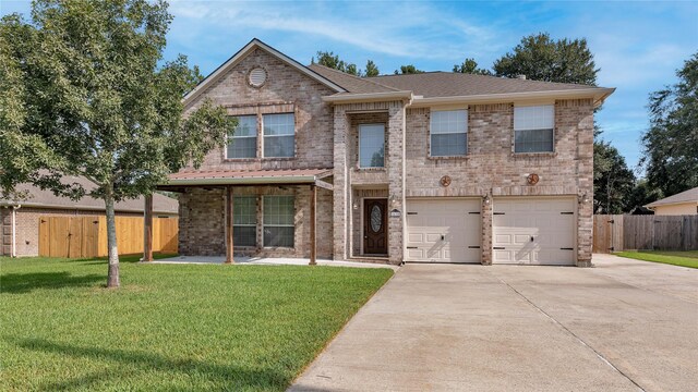 view of front of property with a garage and a front lawn