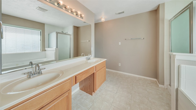 bathroom with vanity, tile patterned floors, and shower with separate bathtub