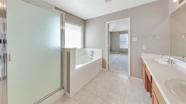 bathroom featuring plenty of natural light, vanity, independent shower and bath, and tile patterned floors