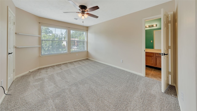 carpeted empty room featuring ceiling fan