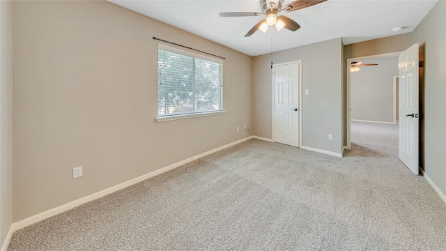 unfurnished bedroom with a closet, ceiling fan, and light carpet