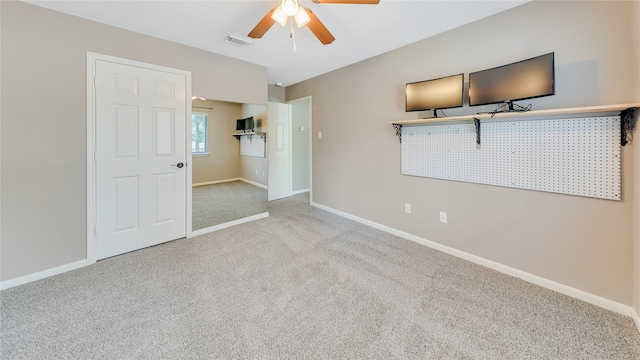 carpeted empty room featuring ceiling fan