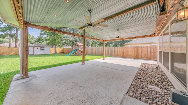 view of patio / terrace featuring a playground, ceiling fan, and a storage shed