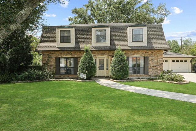 view of front of house with a garage and a front lawn