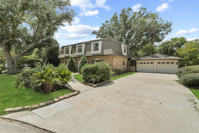 view of front of property featuring a garage and a front yard