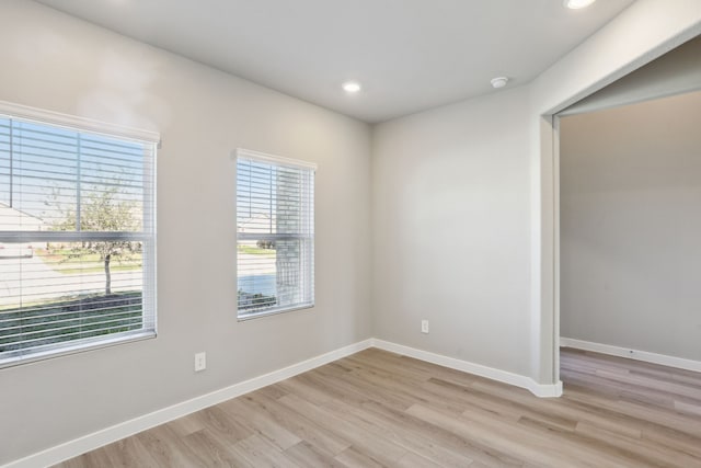 unfurnished room featuring a healthy amount of sunlight and light hardwood / wood-style flooring