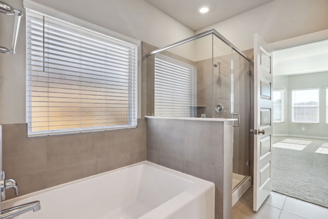 bathroom featuring tile patterned flooring and plus walk in shower