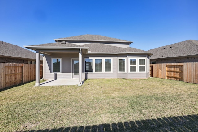 rear view of property with a patio and a lawn