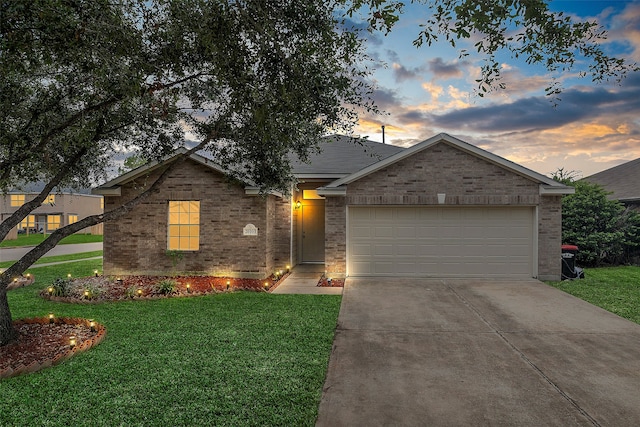 ranch-style home with a lawn and a garage