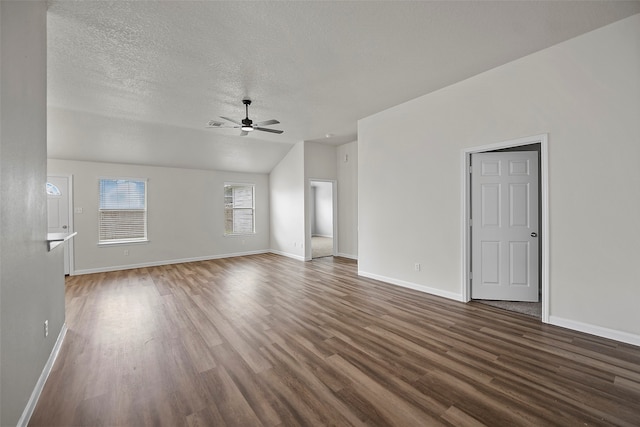 unfurnished living room with vaulted ceiling, dark hardwood / wood-style flooring, ceiling fan, and a textured ceiling