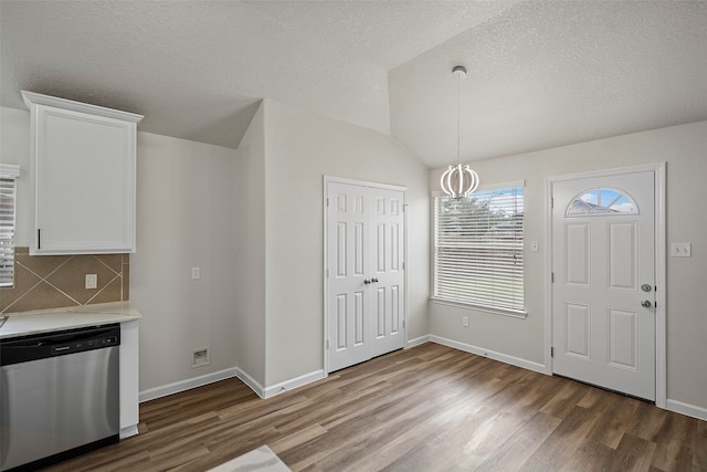 interior space with lofted ceiling, dishwasher, dark hardwood / wood-style floors, and decorative backsplash