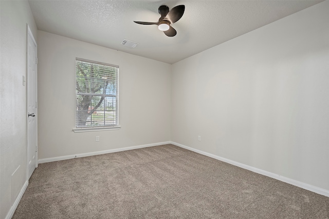 unfurnished room featuring a textured ceiling, ceiling fan, and carpet floors