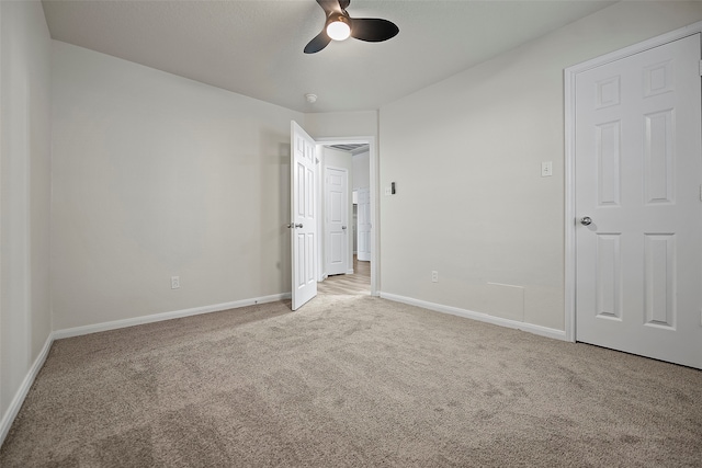 unfurnished bedroom featuring light colored carpet and ceiling fan