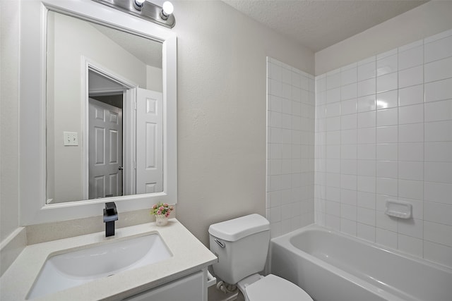 full bathroom with tiled shower / bath combo, vanity, toilet, and a textured ceiling