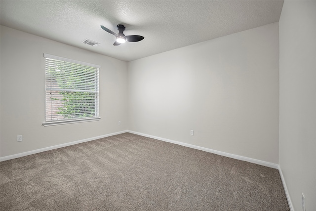 carpeted empty room featuring a textured ceiling and ceiling fan