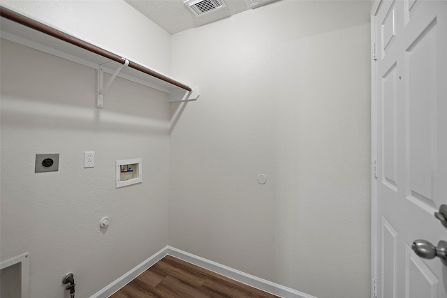 laundry area featuring hookup for a washing machine, hookup for a gas dryer, electric dryer hookup, dark wood-type flooring, and a textured ceiling