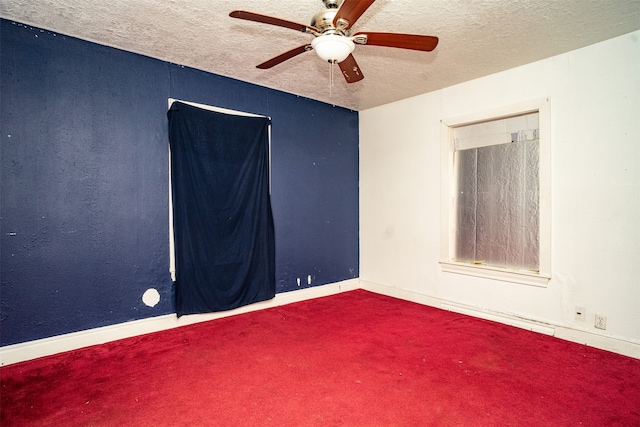 empty room with a textured ceiling, ceiling fan, and carpet floors