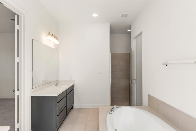 bathroom with tile patterned flooring, vanity, and separate shower and tub