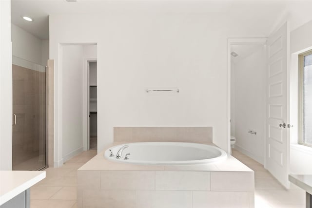 bathroom with tile patterned floors, toilet, and independent shower and bath