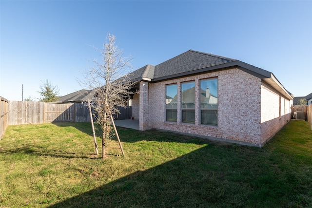 rear view of property with a lawn