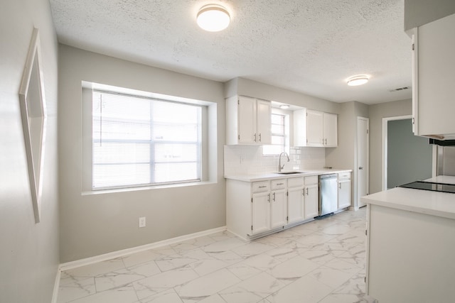 kitchen featuring stainless steel dishwasher, sink, light tile patterned floors, and backsplash