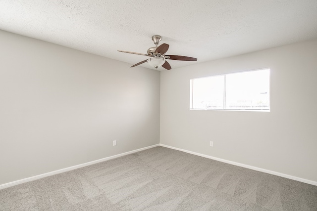 spare room with a textured ceiling, ceiling fan, and carpet floors