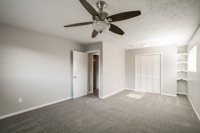 unfurnished bedroom featuring a closet, a textured ceiling, ceiling fan, and carpet floors