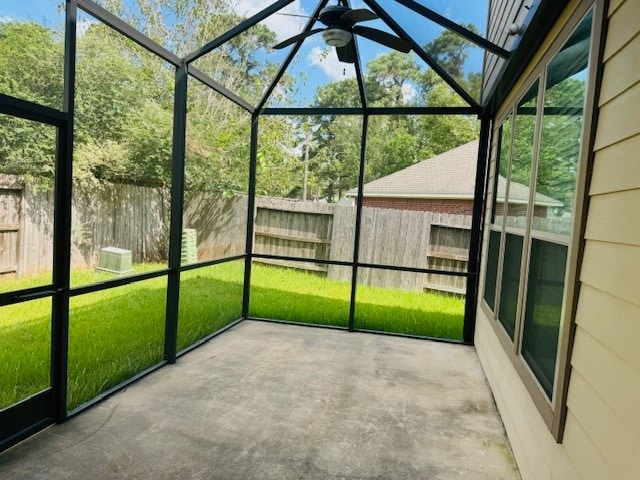 unfurnished sunroom featuring ceiling fan