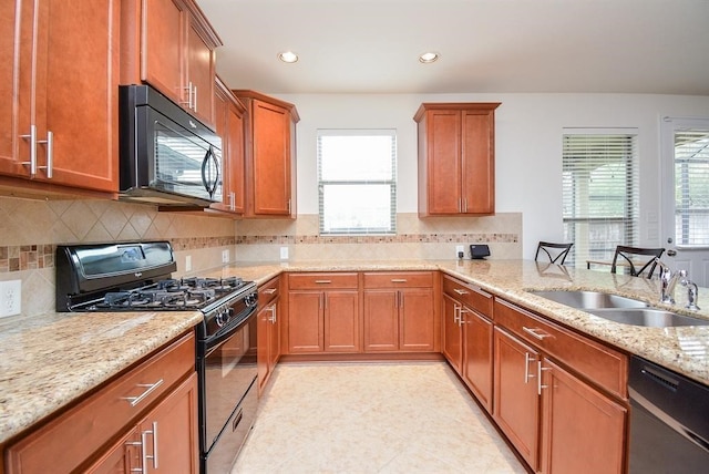 kitchen with black appliances, sink, light tile patterned floors, and backsplash