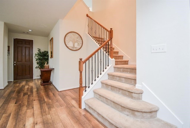 stairs with hardwood / wood-style floors