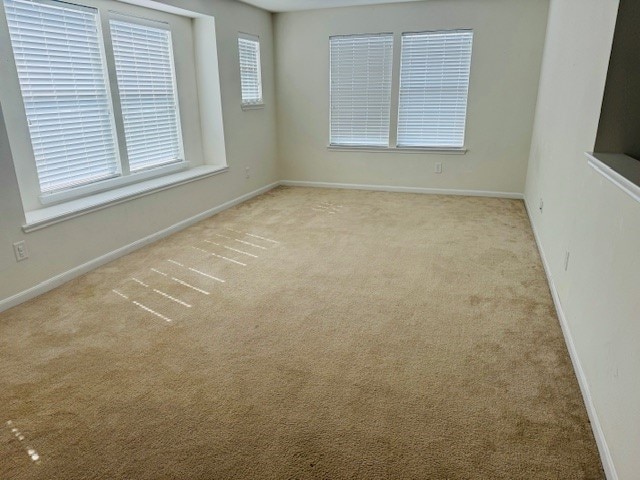 unfurnished room with light colored carpet