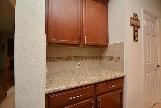 kitchen with light stone counters and decorative backsplash