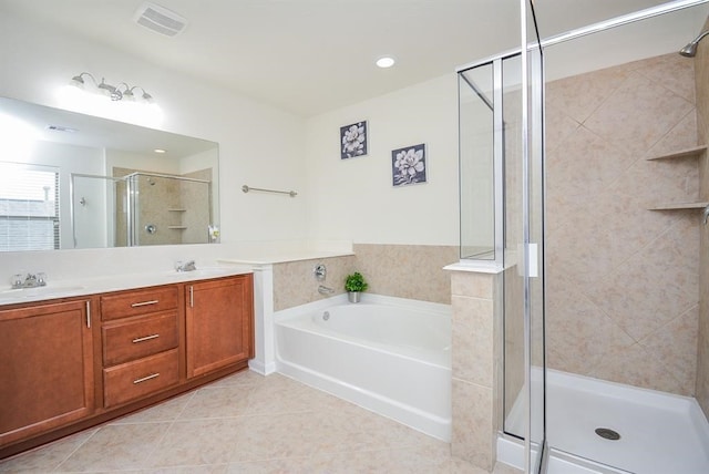 bathroom with shower with separate bathtub, vanity, and tile patterned floors