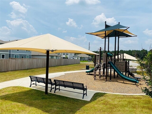 community playground featuring fence and a lawn