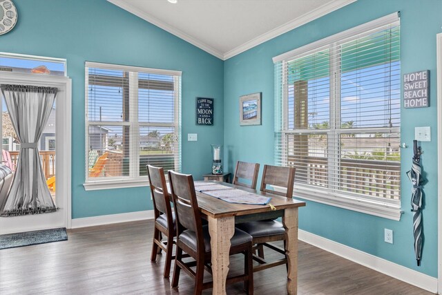 dining space with lofted ceiling, crown molding, and dark hardwood / wood-style flooring