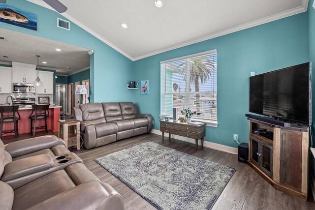 living room featuring ornamental molding, wood-type flooring, vaulted ceiling, and ceiling fan