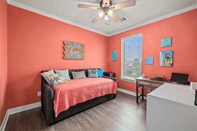 bedroom featuring ceiling fan, hardwood / wood-style flooring, and crown molding