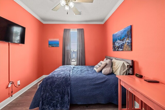 bedroom featuring ornamental molding, ceiling fan, and dark hardwood / wood-style flooring