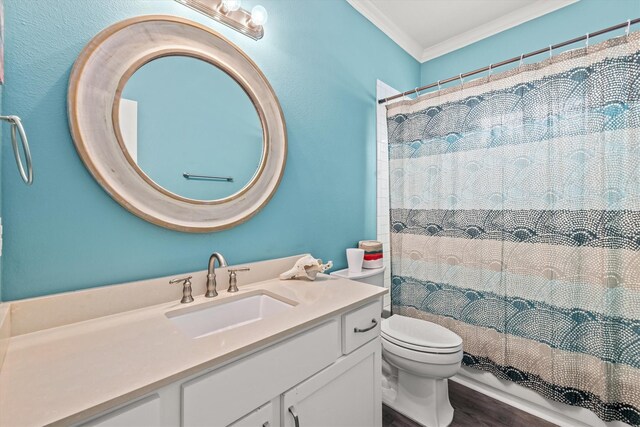 full bathroom featuring wood-type flooring, crown molding, shower / tub combo with curtain, vanity, and toilet