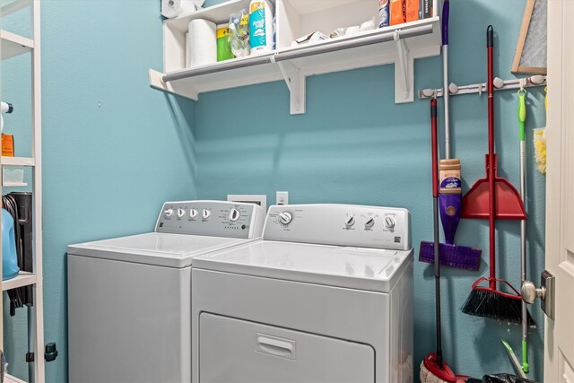 clothes washing area featuring washing machine and clothes dryer