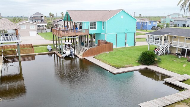 view of dock with a deck with water view and a yard