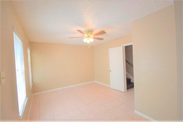 spare room featuring ceiling fan and a textured ceiling